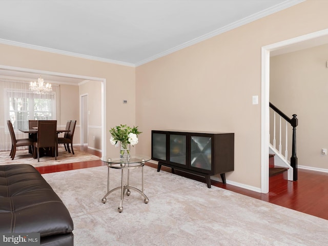2322 Golden Chapel Rd, Odenton, MD 21113 - living room featuring crown molding, wood finished floors, stairway, baseboards, and an inviting chandelier