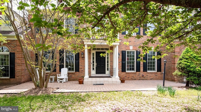 entrance to property with brick siding