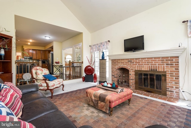 carpeted living area featuring a fireplace and high vaulted ceiling