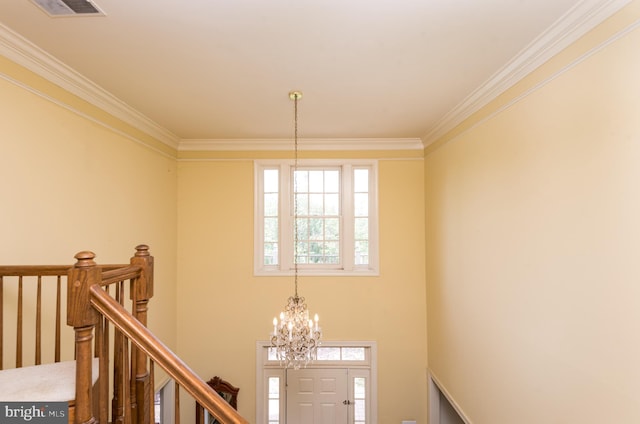interior space with visible vents, a chandelier, and ornamental molding