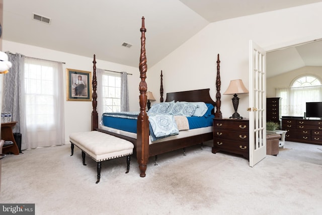 carpeted bedroom featuring visible vents, multiple windows, and vaulted ceiling