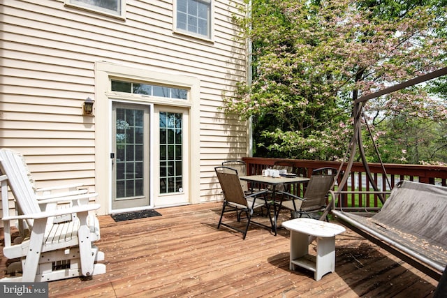 wooden terrace with outdoor dining space