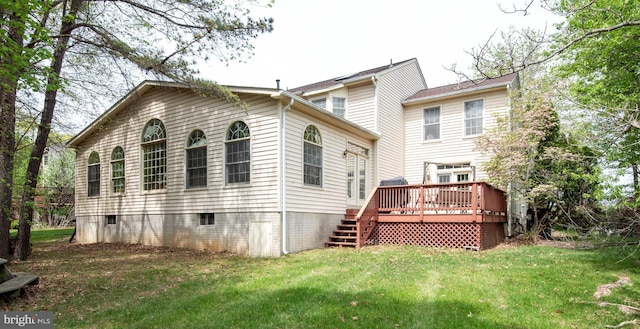 back of house featuring a lawn, a wooden deck, and stairway