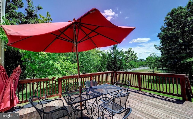 wooden terrace featuring outdoor dining space