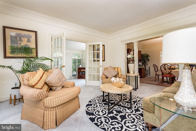 carpeted living area with french doors, crown molding, and decorative columns