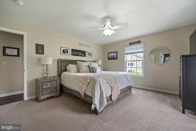 carpeted bedroom with baseboards, visible vents, and a ceiling fan