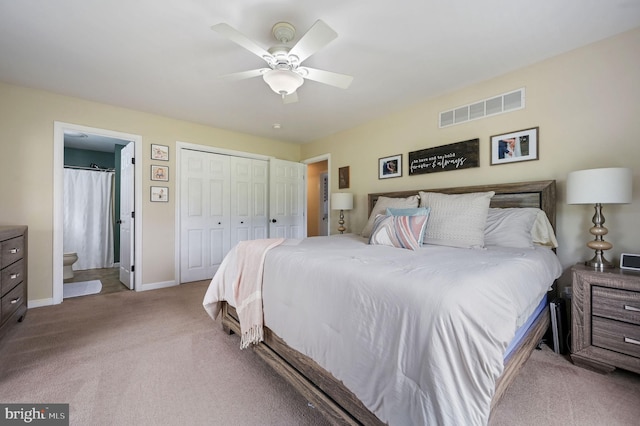 bedroom featuring a closet, visible vents, carpet floors, connected bathroom, and baseboards
