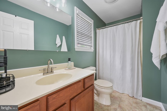 bathroom with toilet, vanity, and curtained shower