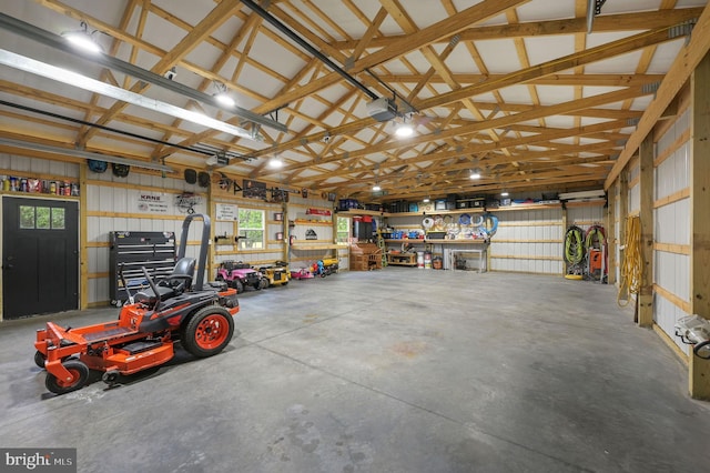 garage with a garage door opener and a workshop area