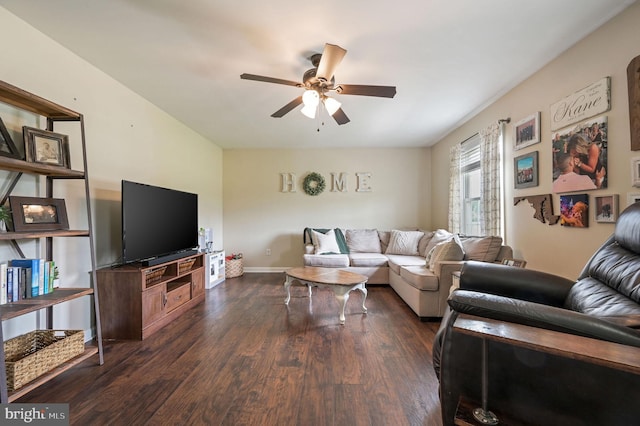 living area featuring dark wood-style flooring, baseboards, and ceiling fan