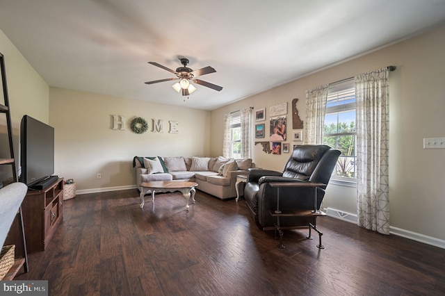living room featuring a ceiling fan, baseboards, and wood finished floors