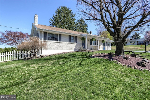 ranch-style house featuring a front lawn, fence, and a chimney