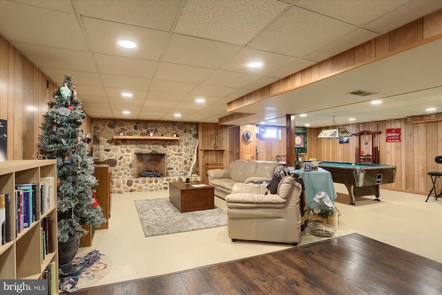 living room featuring billiards, visible vents, wooden walls, a fireplace, and wood finished floors