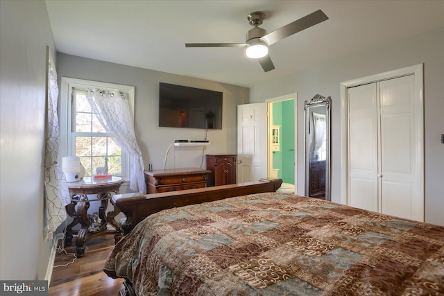 bedroom featuring wood finished floors, a ceiling fan, baseboards, and a closet