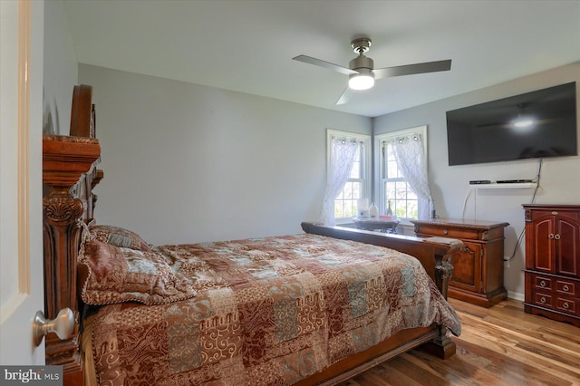 bedroom with light wood finished floors and a ceiling fan
