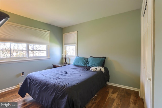 bedroom with hardwood / wood-style flooring and baseboards