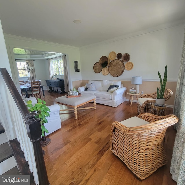 living room with ornamental molding and wood finished floors