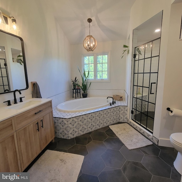 full bath featuring a shower stall, toilet, a bath, vanity, and a notable chandelier
