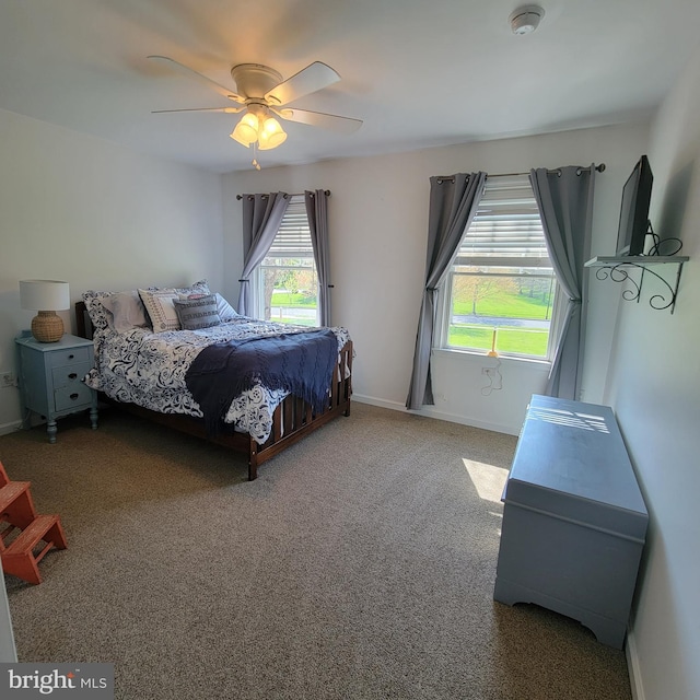 bedroom with carpet floors, ceiling fan, and baseboards