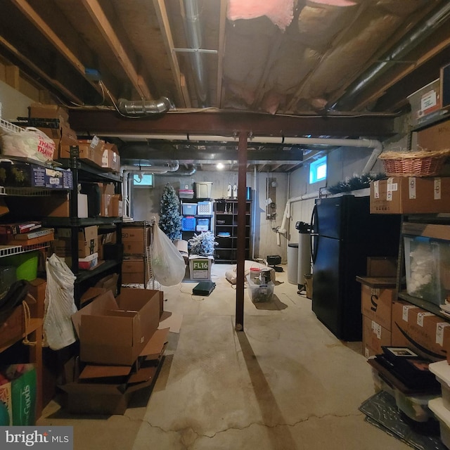 basement featuring freestanding refrigerator