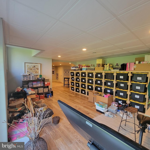 exercise room with recessed lighting and wood finished floors