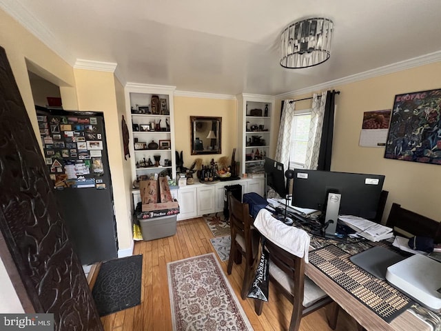 home office featuring light wood-type flooring and ornamental molding
