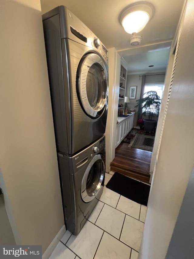 washroom with stacked washer / drying machine and laundry area