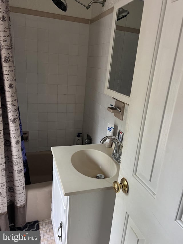 full bath featuring shower / bath combo with shower curtain and vanity