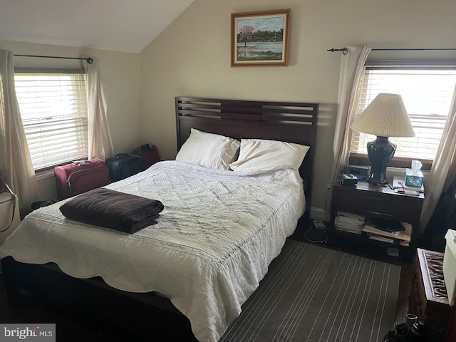 carpeted bedroom featuring multiple windows and vaulted ceiling