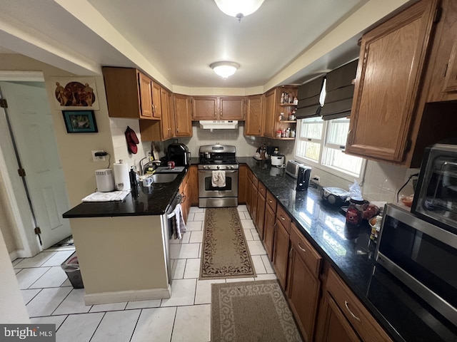 kitchen featuring brown cabinets, open shelves, a sink, stainless steel appliances, and under cabinet range hood