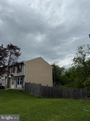 22 Morning Ct, Rosedale, MD 21237 - view of side of home with a lawn and fence