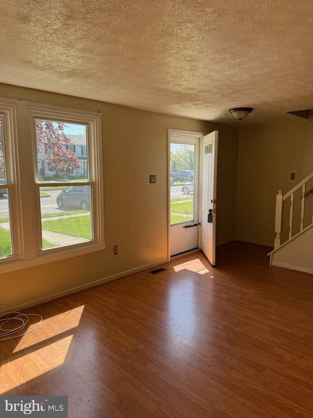 22 Morning Ct, Rosedale, MD 21237 - interior space featuring baseboards, visible vents, a textured ceiling, and wood finished floors