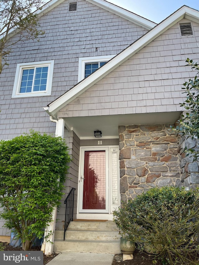 property entrance featuring stone siding