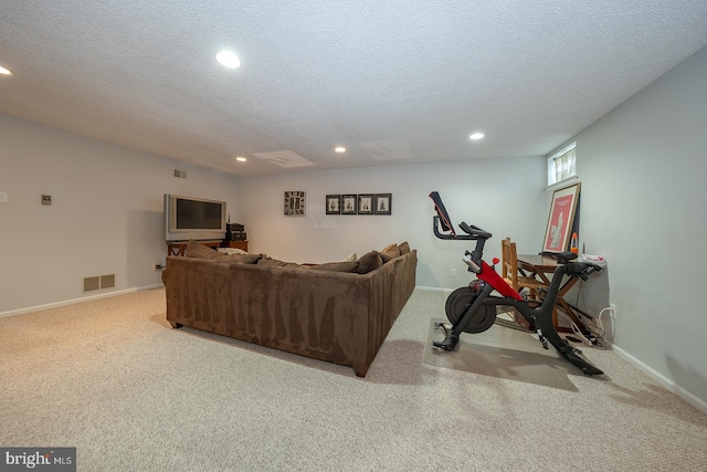 carpeted living area with recessed lighting, a textured ceiling, visible vents, and baseboards