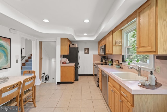 kitchen with a sink, appliances with stainless steel finishes, recessed lighting, and light countertops