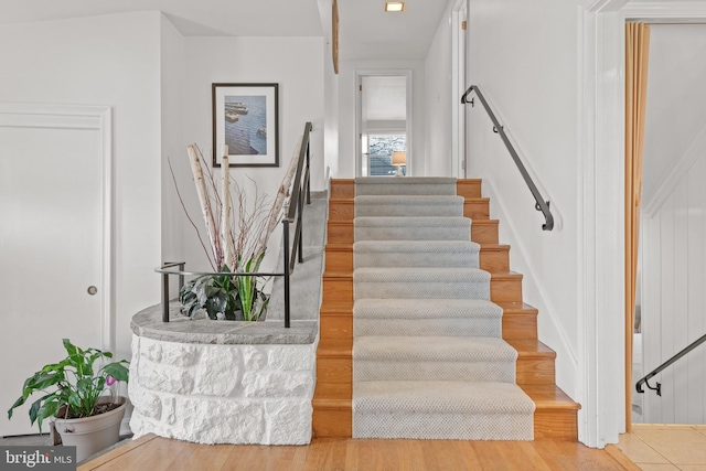 stairway with wood finished floors