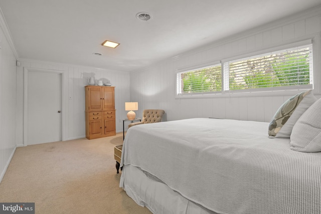 bedroom featuring ornamental molding and light carpet