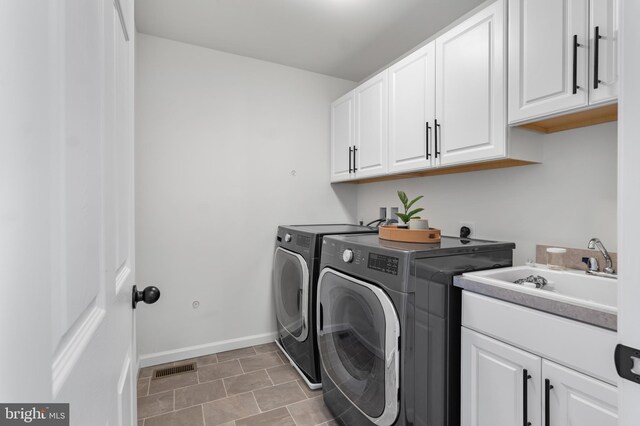 194 Cool Springs Road, North East, MD 21901 - washroom with cabinet space, a sink, baseboards, visible vents, and washing machine and dryer