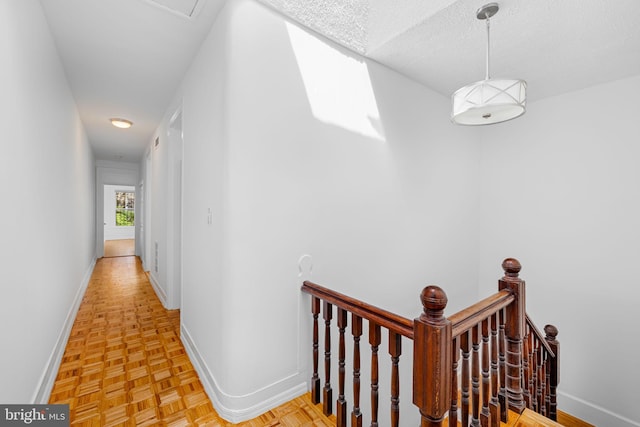 1524 5th St NW, Washington, DC 20001 - corridor featuring baseboards, a textured ceiling, and an upstairs landing
