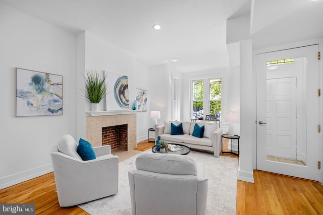1524 5th St NW, Washington, DC 20001 - living room featuring baseboards, wood finished floors, and a tile fireplace