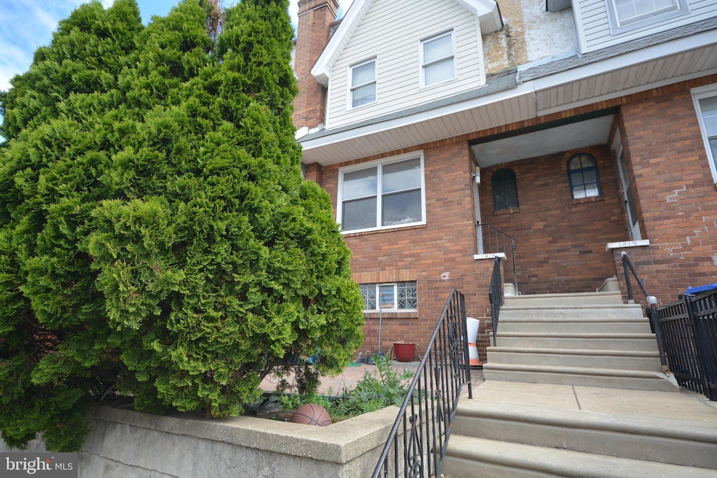 exterior space with a chimney and brick siding