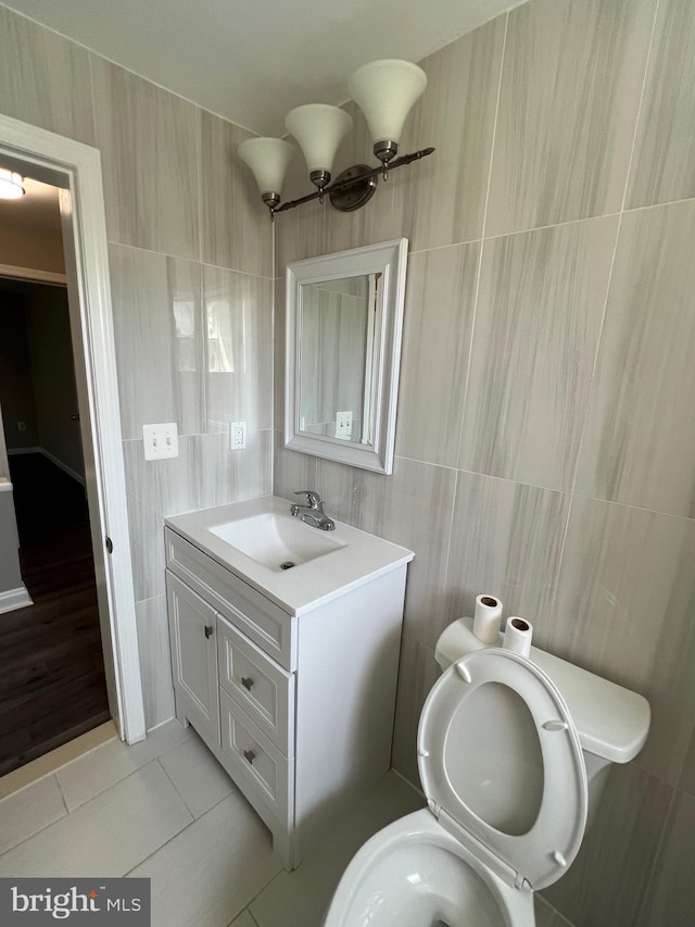 1948 Victory Dr, Baltimore, MD 21227 - bathroom featuring tile walls, vanity, tile patterned floors, and toilet