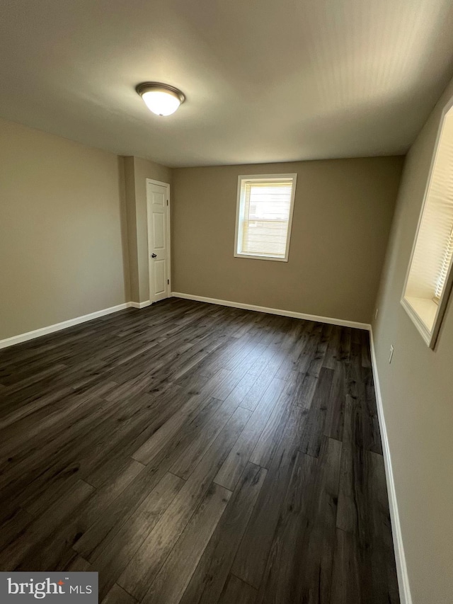 1948 Victory Dr, Baltimore, MD 21227 - empty room with dark wood-style flooring and baseboards