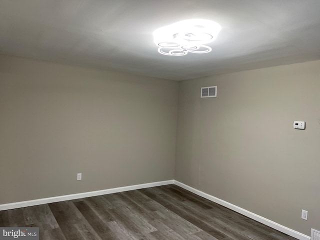 1948 Victory Dr, Baltimore, MD 21227 - unfurnished room featuring baseboards, dark wood-style flooring, and visible vents