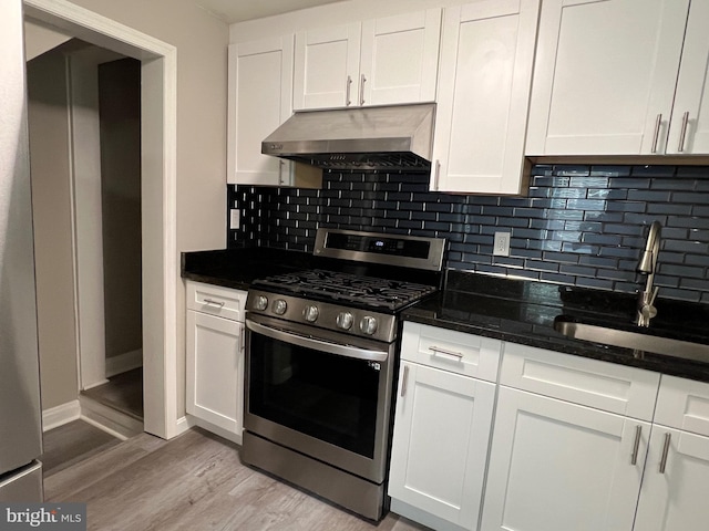 1948 Victory Dr, Baltimore, MD 21227 - kitchen with decorative backsplash, stainless steel gas range oven, under cabinet range hood, white cabinets, and a sink
