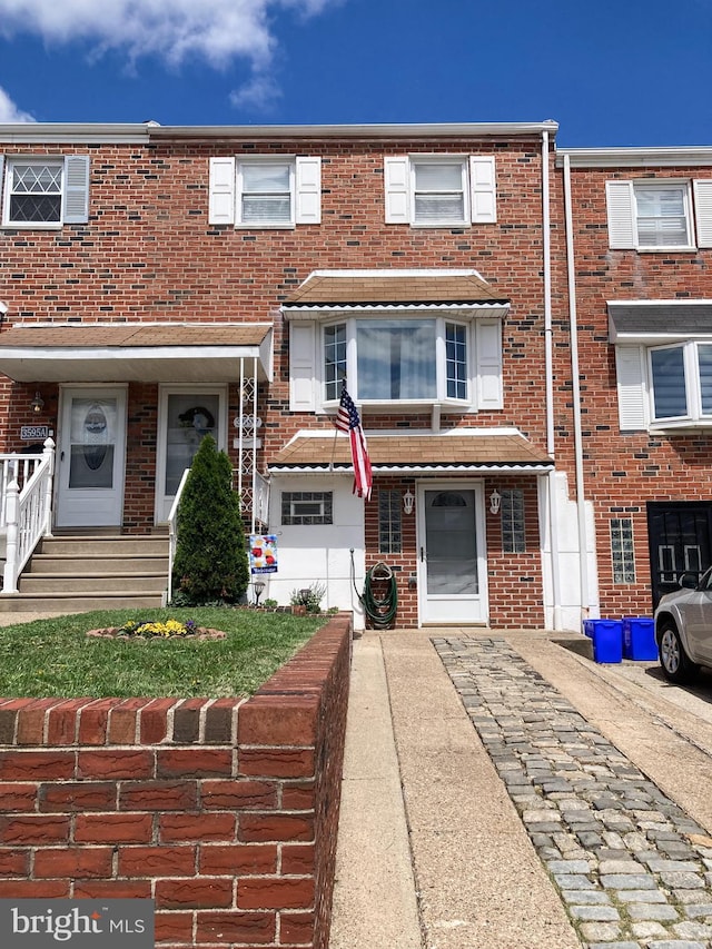 townhome / multi-family property with brick siding