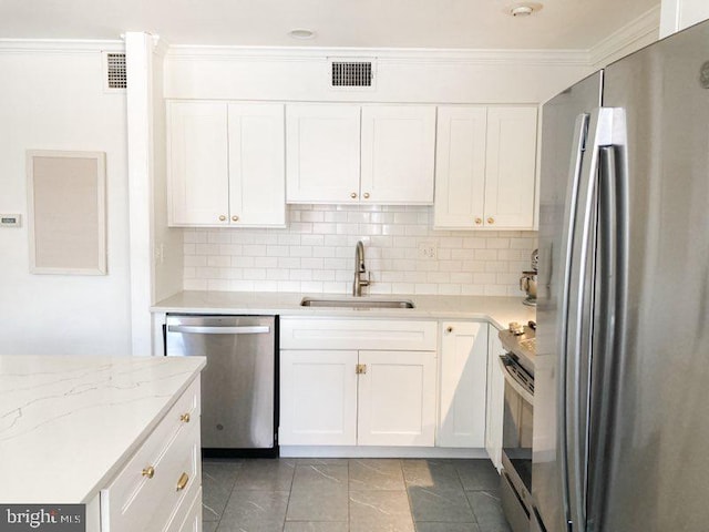kitchen with white cabinetry, appliances with stainless steel finishes, a sink, and visible vents