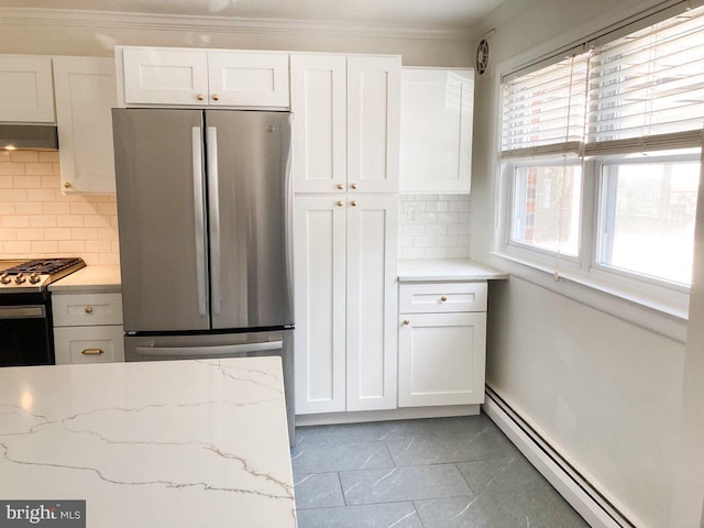 kitchen featuring appliances with stainless steel finishes, baseboard heating, under cabinet range hood, and white cabinetry