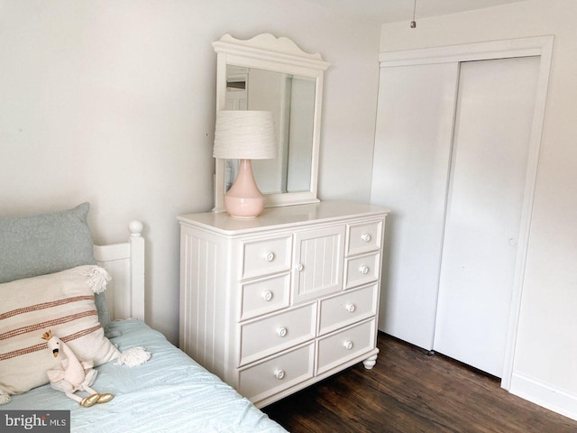bedroom featuring a closet and dark wood-type flooring
