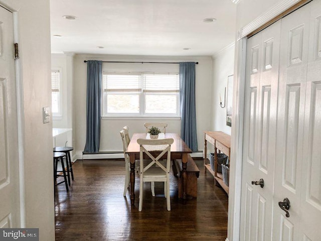dining room with crown molding, dark wood-style flooring, baseboards, baseboard heating, and a baseboard heating unit
